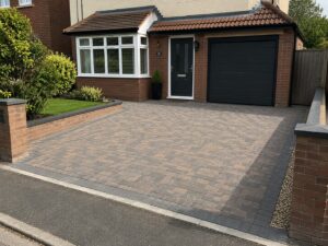 Modern block paving driveway installation outside a residential property in South Wales with decorative edging and front garden landscaping.